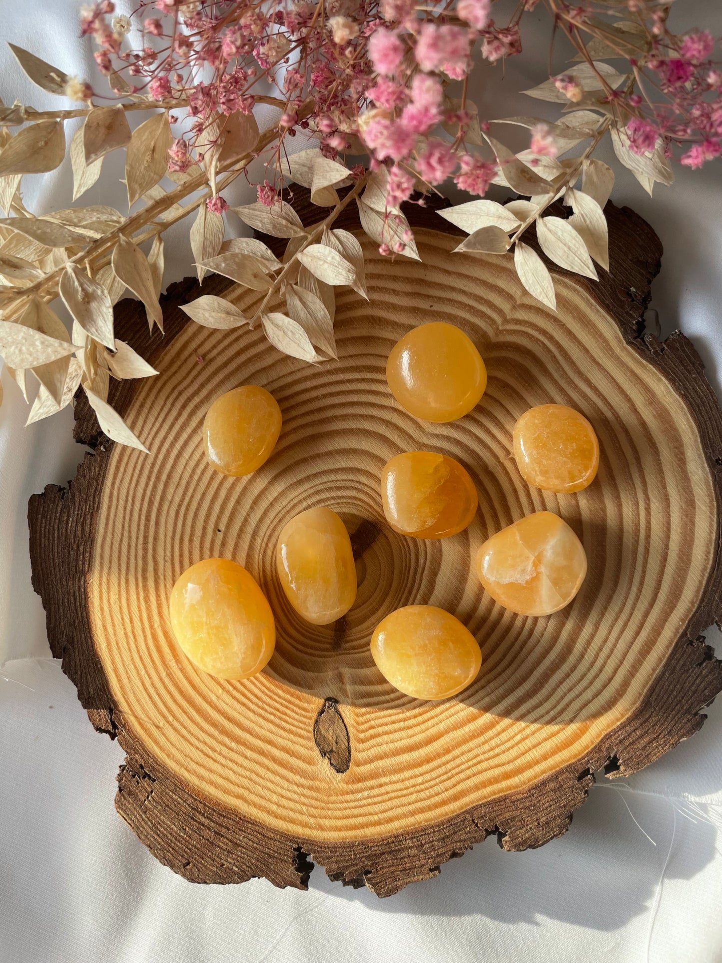 Orangencalcit Trommelstein